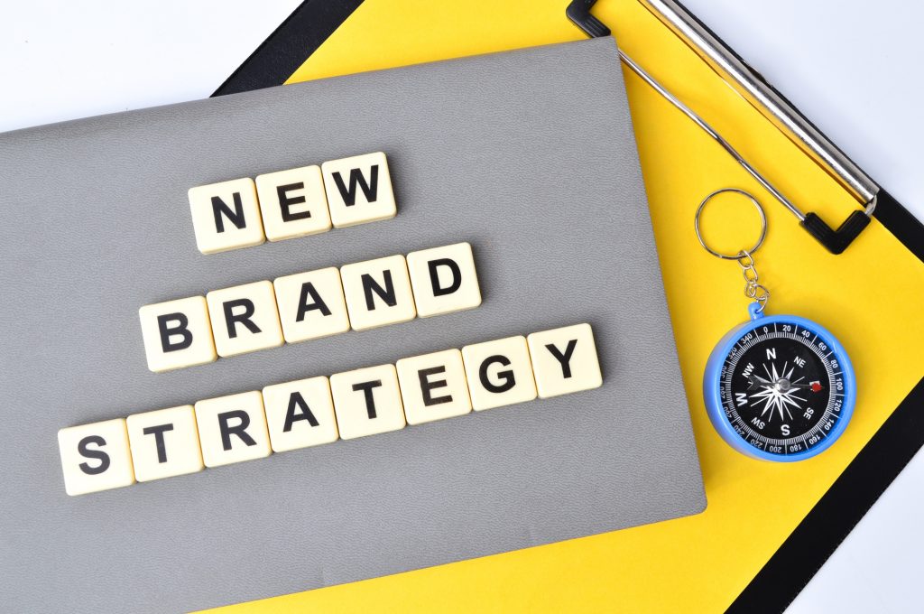 Top view of square letters with text NEW BRAND STRATEGY.